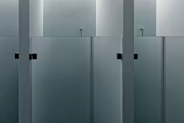 frameless glass shower doors utilized at a public restroom