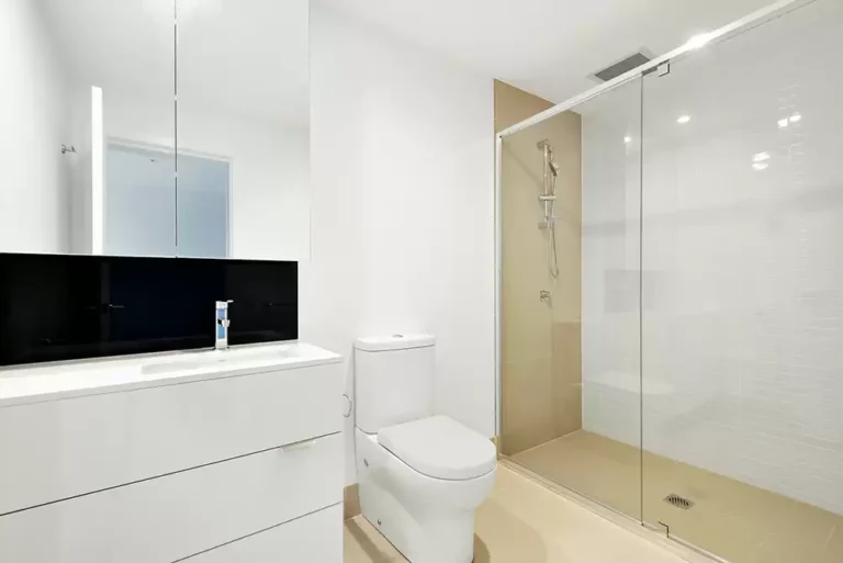 A clean and modern shower with glass doors.