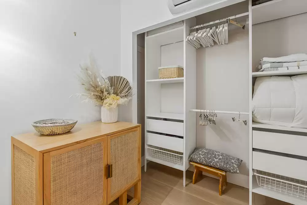 A white, modern, and clean closet.